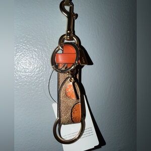 Coach Trigger Snap Bag Charm In Signature Canvas With Orange Print